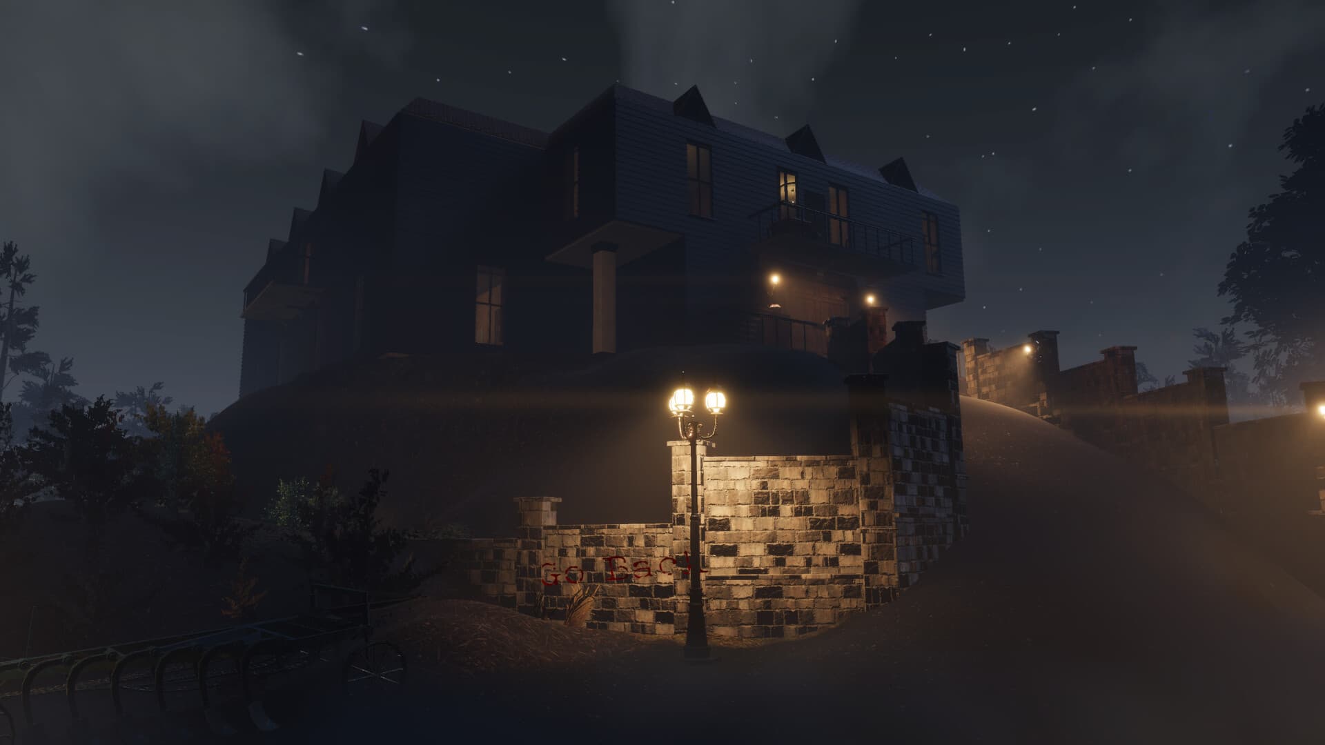 Karakam Manor with warmly lit windows in the night mist